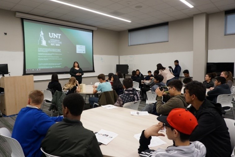 UNT staff talks to students in classroom