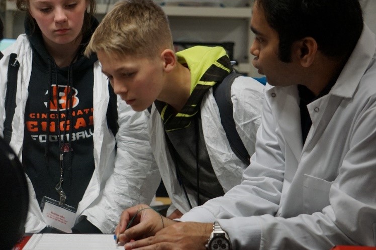 Three students doing experiment