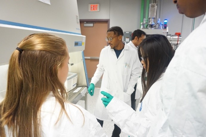 UNT researcher showing students equipment