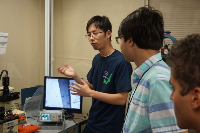 UNT researcher with students in a lab