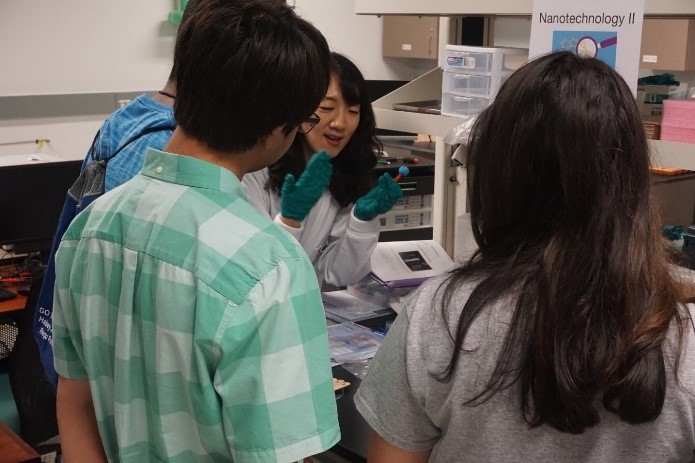 UNT researcher showing students experiment